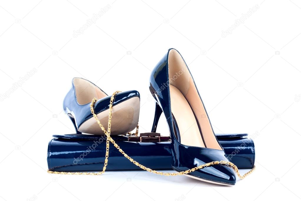 Beautiful blue shoes with clutches on white isolated background