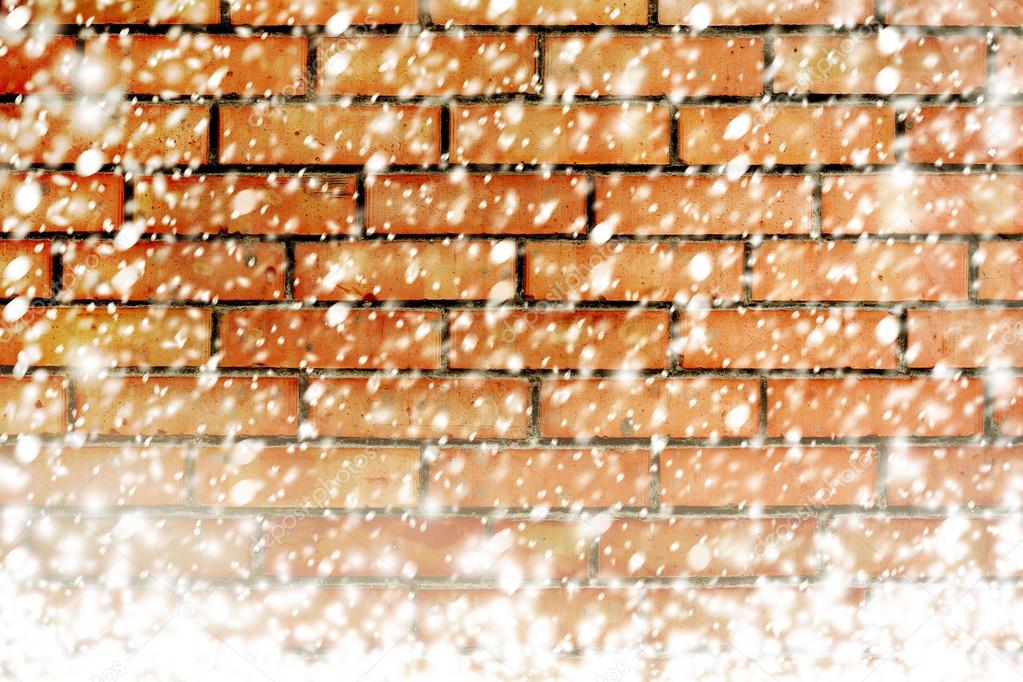 Texture of red brick wall with white snow flakes