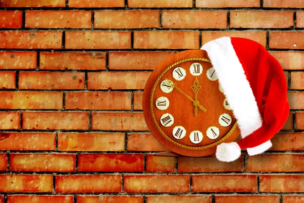 Santa Claus hat on New Year's night on the old clock showing twe — Stock Photo, Image