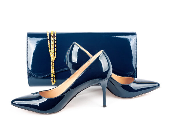 Beautiful blue shoes with clutches on white isolated background