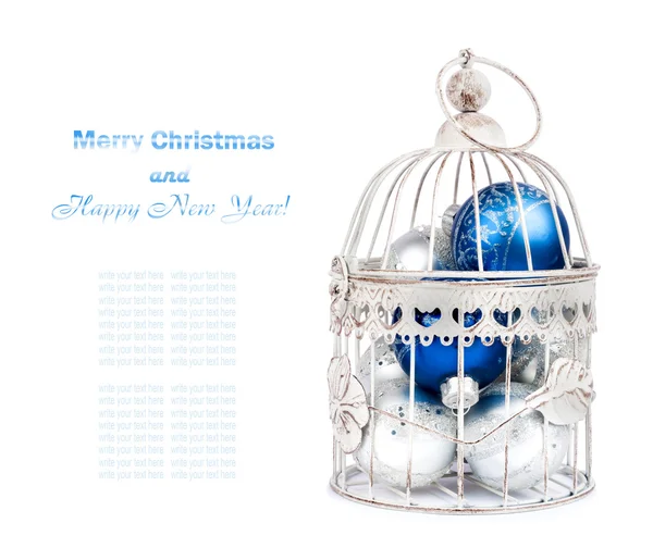 Blue and silver christmas balls in cage on the  isolated white b — Stock Photo, Image