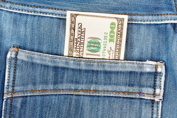 A hundred dollar bills sticking in the back pocket of denim blue — Stock Photo, Image
