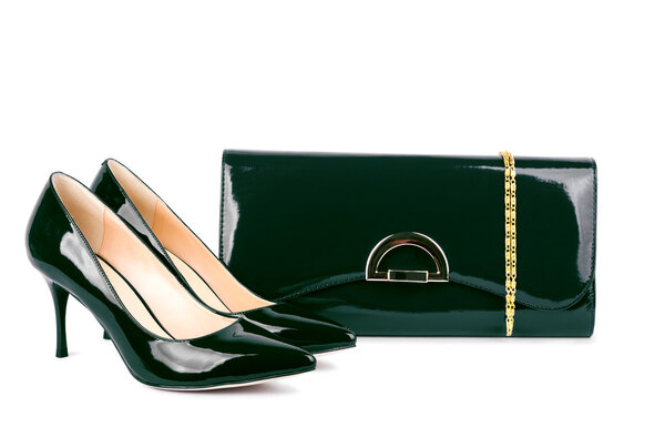 Beautiful green shoes with clutches on white isolated background