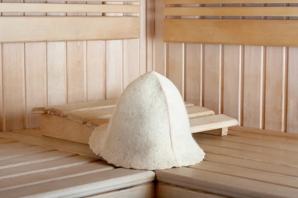 Traditional wooden sauna for relaxation with felt hat — Stock Photo, Image