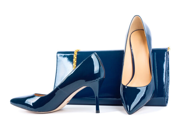 Beautiful blue shoes with clutches on white isolated background