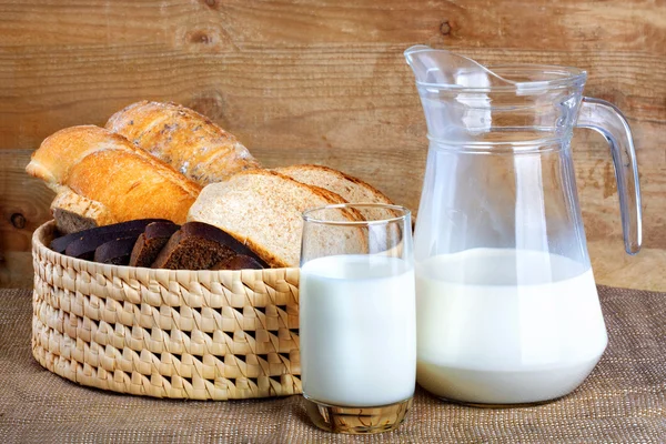 Bread from rye and wheat flour of rough grinding and glass milk — Stock Photo, Image