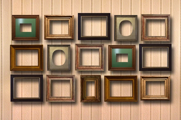 Gilded wooden frames for pictures on background