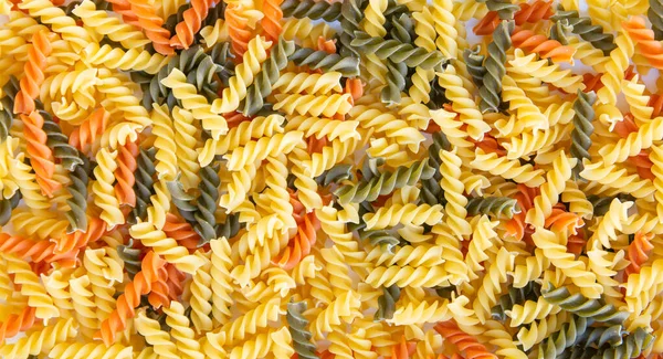 Yellow Green Orange Spiral Pasta Background — Stock Photo, Image