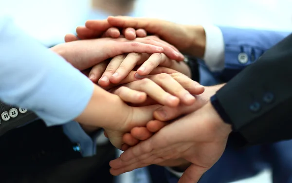 Close-up of business partners making pile of hands at meeting — Stock Photo, Image