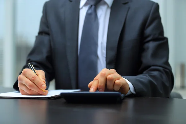 Businessman Using Calculator In Office — Stock Photo, Image