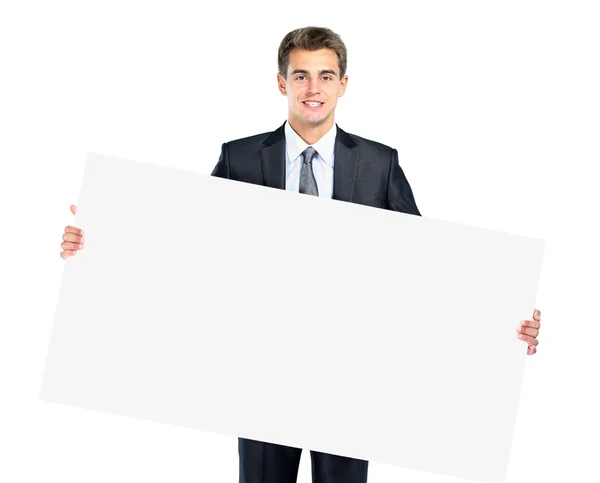 Feliz sorridente jovem homem de negócios mostrando placa em branco — Fotografia de Stock