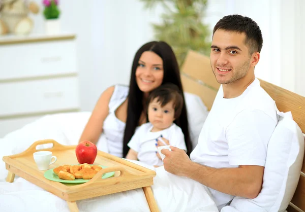 Smiling family having breakfast — Stock Photo, Image