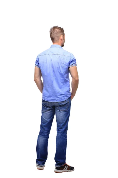 Young man from the back - looking at something over a white back — Stock Photo, Image