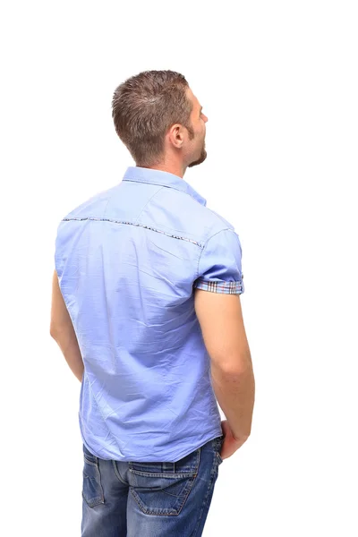 Young man from the back - looking at something over a white back — Stock Photo, Image