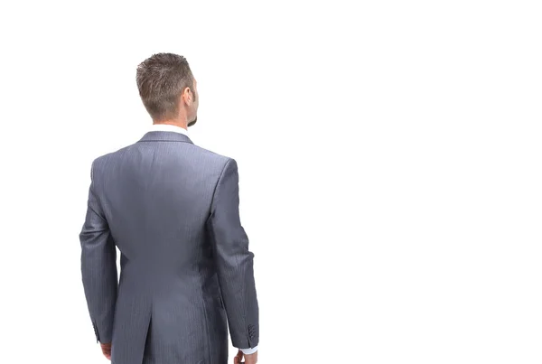 Businessman from the back - looking at something over a white ba — Stock Photo, Image
