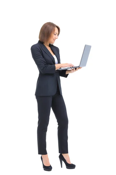 Beautiful businesswoman keeps the laptop. — Stock Photo, Image