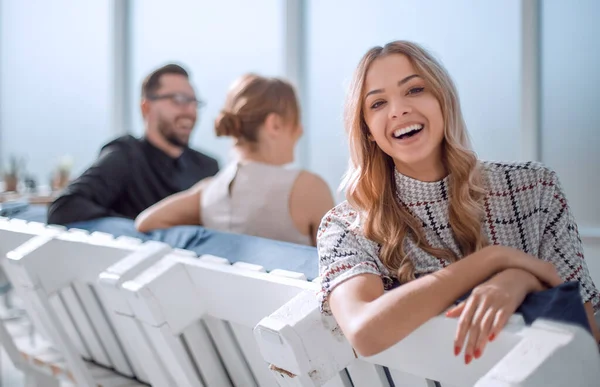 young business woman sitting in office lobby at coffee break