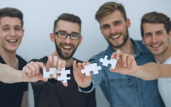 Image of the guys connecting pieces of the puzzle — Stock Photo, Image