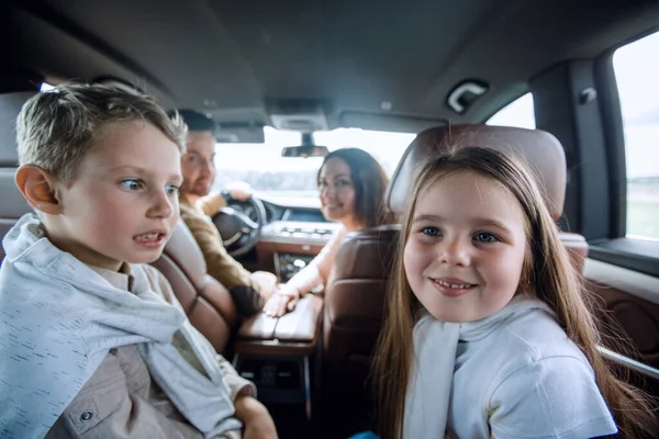 children sitting in the back seat of the car