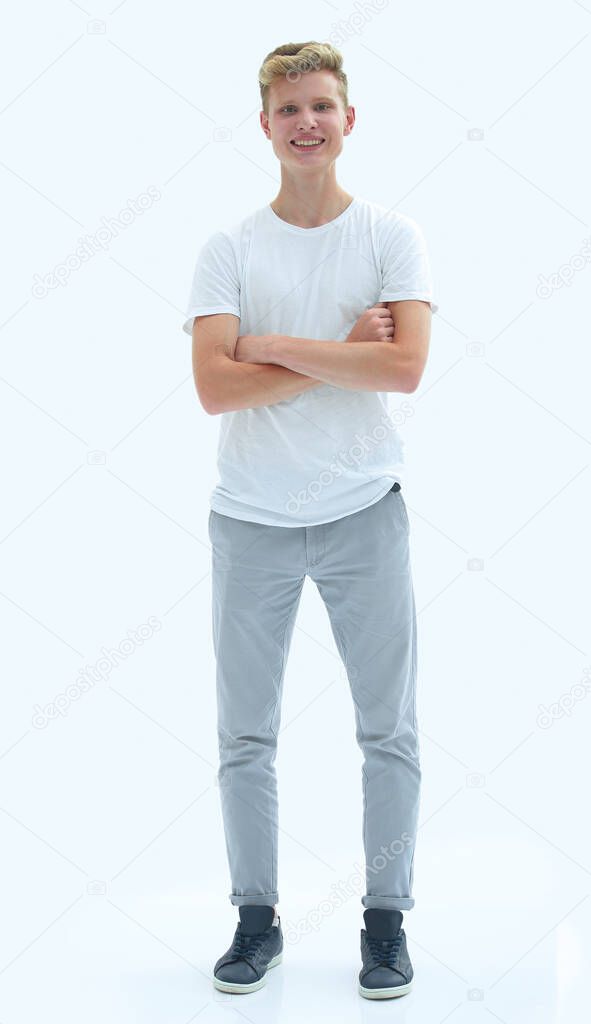 in full growth. smiling guy in jeans and a white t-shirt.