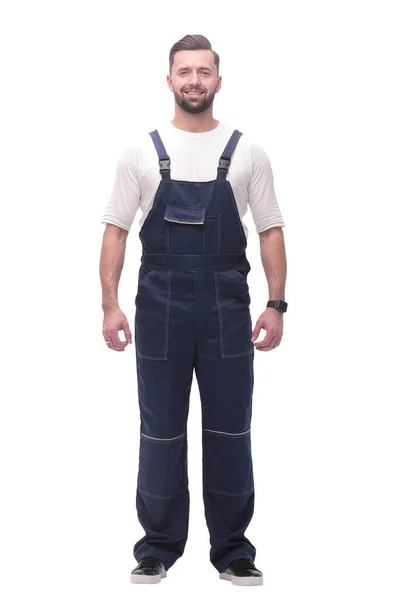 Selbstbewusster junger Mann in blauen Overalls. isoliert auf weiß — Stockfoto