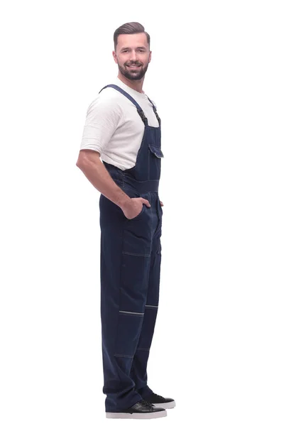 Side view. smiling man in overalls looking forward to copy space — Stock Photo, Image