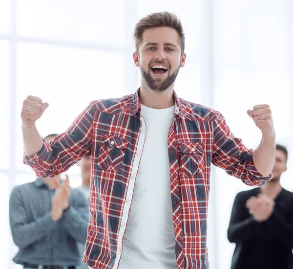 Líder jubiloso de pie frente al equipo de negocios. — Foto de Stock