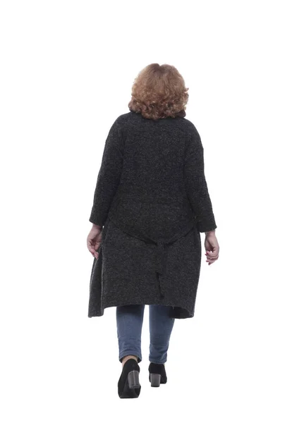 Rear view. mature woman in a fashionable cardigan walking away — Stock Photo, Image