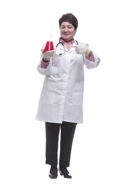 Medical woman points to a bottle of red liquid — Stock Photo, Image