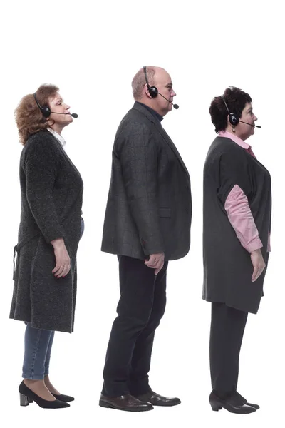 Vista lateral. grupo de personas en un auricular de pie en una fila — Foto de Stock