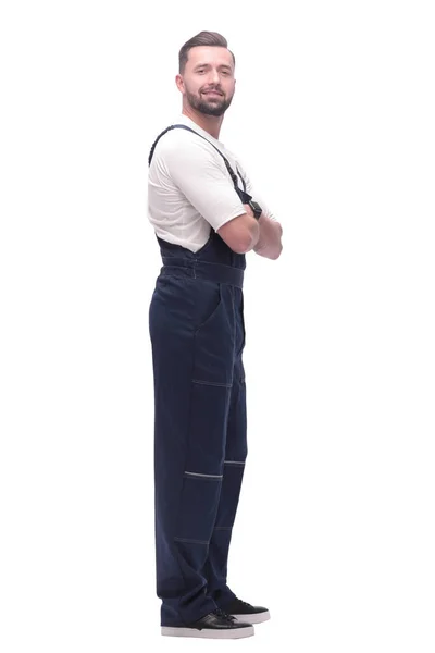 Side view. smiling man in overalls looking forward to copy space — Stock Photo, Image