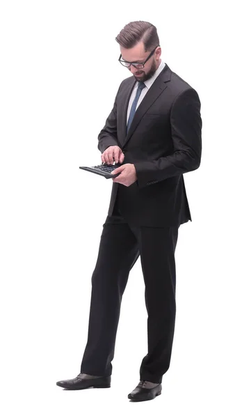 In full growth. Confident businessman counting on calculator — Stock Photo, Image