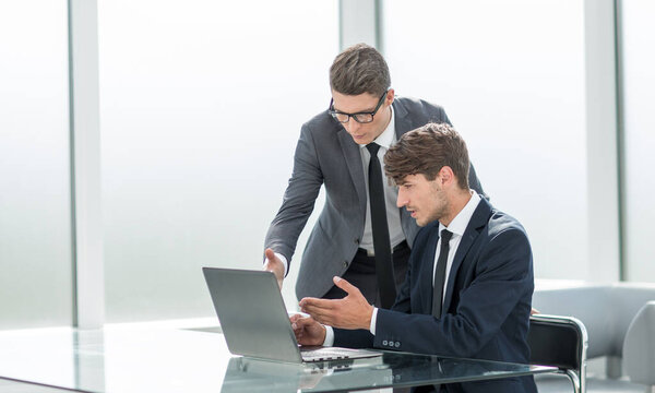 business people discuss something sitting at the office table.