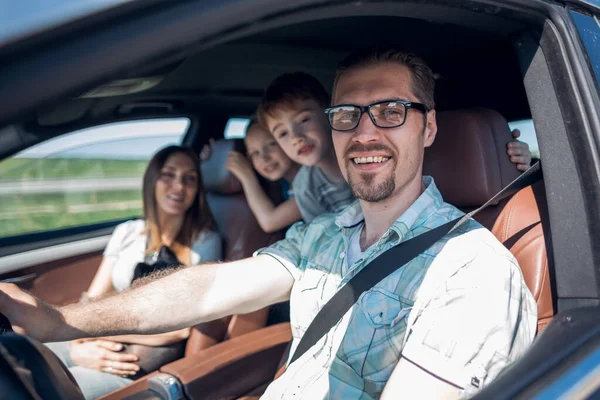 Side view.happy father driving a car — Stock Photo, Image