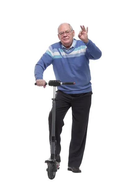 In full growth. senior man with an electric scooter — Stock Photo, Image