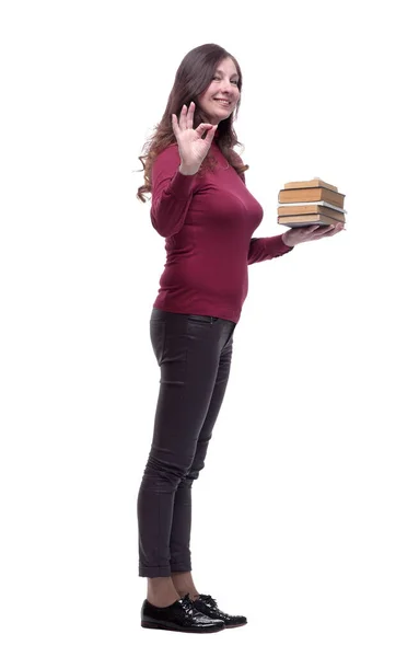 In full growth. a friendly young woman with a stack of books — Stock Photo, Image