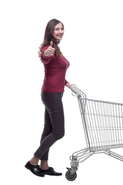 Side view. casual young woman pushing shopping cart — Stock Photo, Image