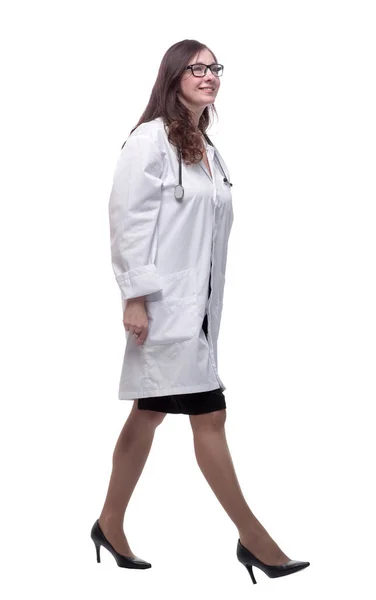 Side view. a smiling woman doctor striding forward — Stock Photo, Image