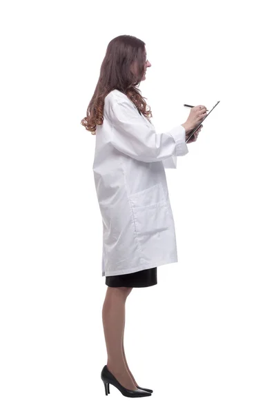 In full growth. young doctor making notes in the clipboard — Stock Photo, Image