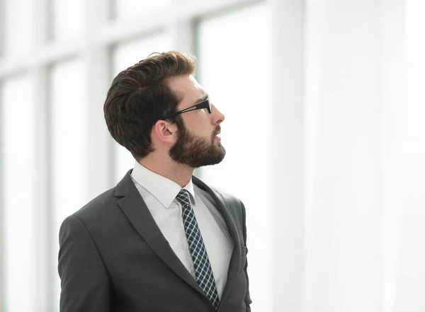 Side view. businessman looking through office window — Stock Photo, Image