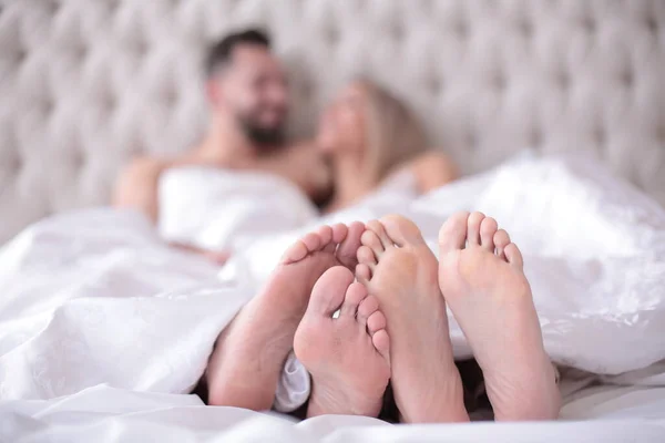 Background image of a couple in love lying on the bed — Stock Photo, Image