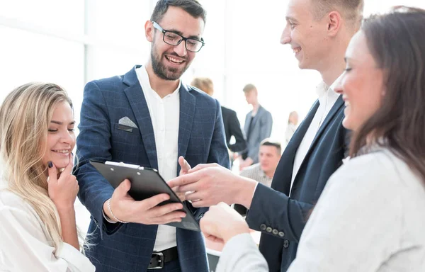 close up. smiling employees discussing a business document