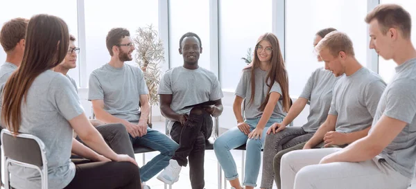 Entrenador y grupo de discusión de jóvenes sentados en círculo — Foto de Stock