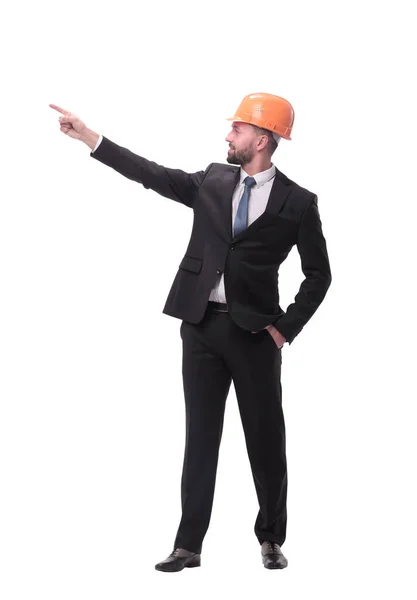 In full growth. young businessman in helmet pointing to copy space — Stock Photo, Image