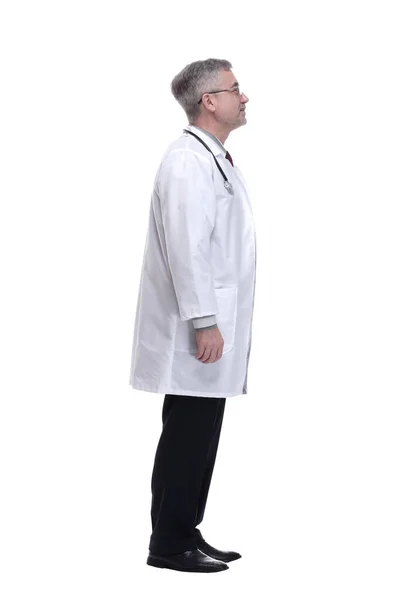 Side view. a smiling doctor reading an ad on a white wall — Stock Photo, Image