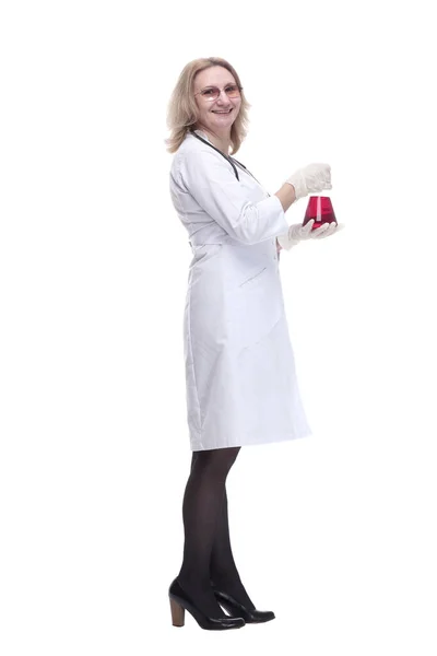 Female doctor with a laboratory flask looking forward. — Stock Photo, Image