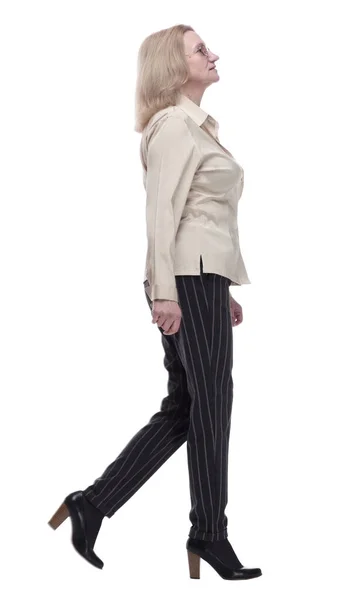 Confident woman in fashionable trousers striding forward — Stock Photo, Image