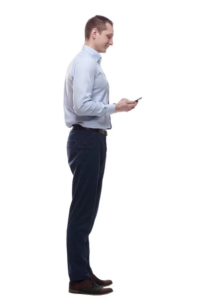Smiling young man cheats SMS. isolated on a white — Stock Photo, Image