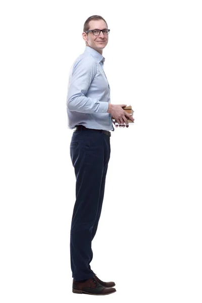 Casual man with a stack of books looking at a white screen. — 图库照片