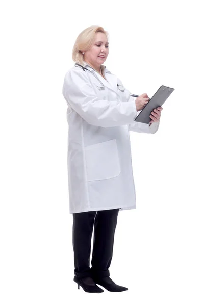 Profile of a pretty doctor with white lab coat, stethoscope smiling and writing notes in clipboard — Stock Photo, Image